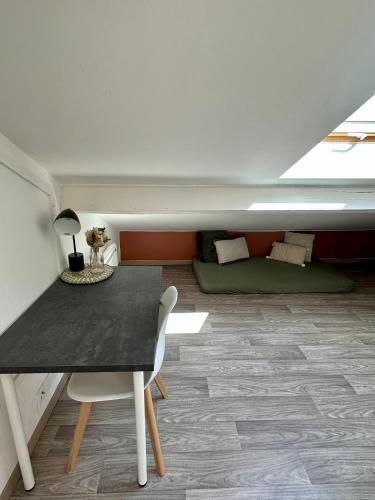 a living room with a table and a couch at La Barbotine - Cosy - Centre ville in Bourg-en-Bresse