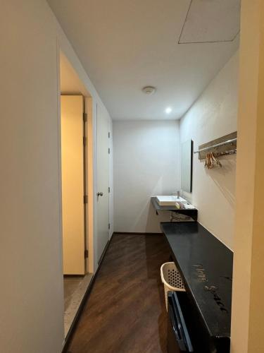 an empty room with a black counter and a door at One More Space in Chiang Mai