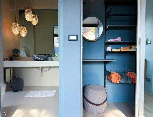 a bathroom with blue walls and a sink and a mirror at Contemporary 3bd Safari Pool Villa Near Nai Yang Beach in Ban Bo Han