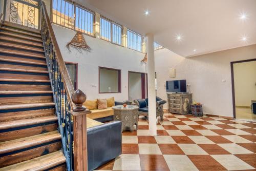 a living room with a staircase and a couch at Matia Agadir - Roof-Top - 4 Px in Agadir