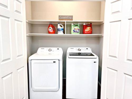 a refrigerator and a washer and dryer in a kitchen at Spacious 3 BR near Legacy West in Plano