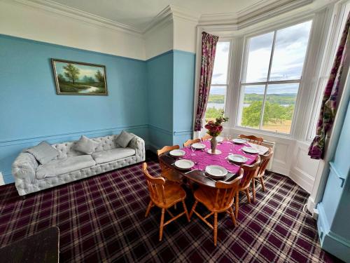 a living room with a table and a couch at Ardbrecknish House in Dalmally