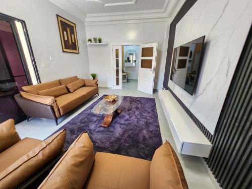 a living room with a couch and a table at F3 Appart Les Ambassades - Point E - Dakar in Dakar