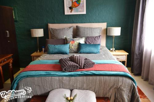 a bedroom with a large bed with pillows on it at Clarky's Bucketlist in Dullstroom