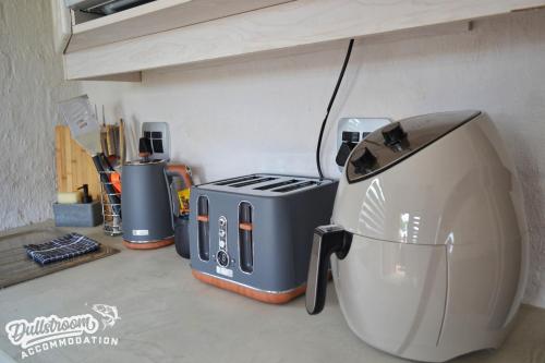a kitchen counter with a toaster and a toaster and a printer at Clarky's Bucketlist in Dullstroom
