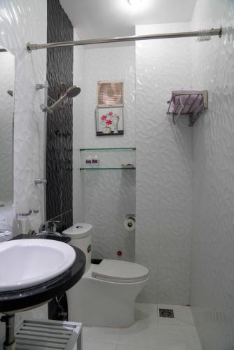 a bathroom with a toilet and a sink at HT Hotel Apartment in Ho Chi Minh City