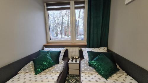 a small room with a couch and a window at Modlin Deluxe Suite in Nowy Dwór Mazowiecki