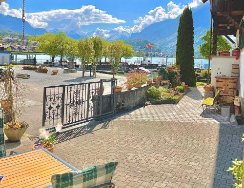a patio with a fence and a table and benches at Romantic Lake & Mountain apartment Pure Swissness in Brienz