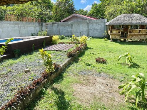 a garden with a wooden walkway in a yard at Milani's farm and mini resort in Indang