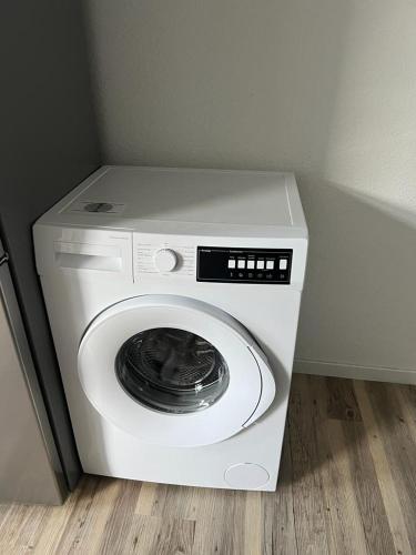 a white washing machine in a corner of a room at Timeless: 3 Zimmer Maisonette-Wohnung in Villingen-Schwenningen in Villingen-Schwenningen