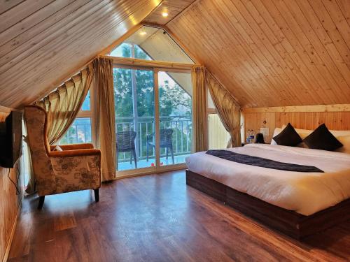 a bedroom with a bed and a large window at Kukoo's Nest Kasauli in Kasauli