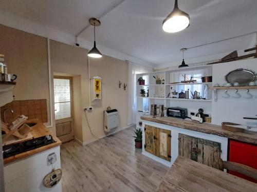 a large kitchen with wooden floors and white walls at La Corte dei Cerri, Il Tornio in Spervara