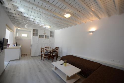 a living room with a couch and a table at Andriani's Guest House in Mýkonos City