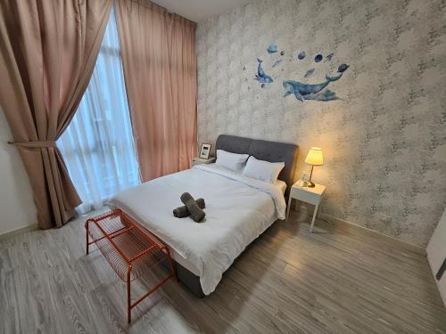 a bedroom with a bed with a teddy bear on it at Setia Sky88 Johor Bahru in Johor Bahru