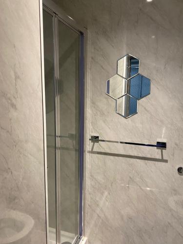 a shower in a bathroom with a glass door at Holiday Plus - Holmfield Road in Blackpool
