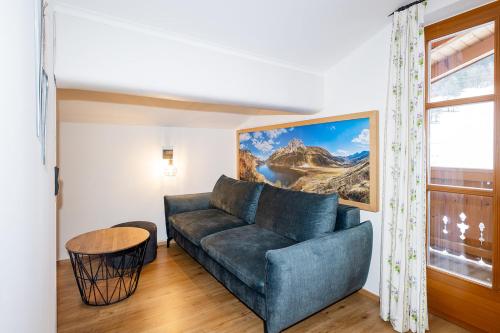 a living room with a couch and a window at Ferienparadies Taxen in Sankt Veit im Pongau