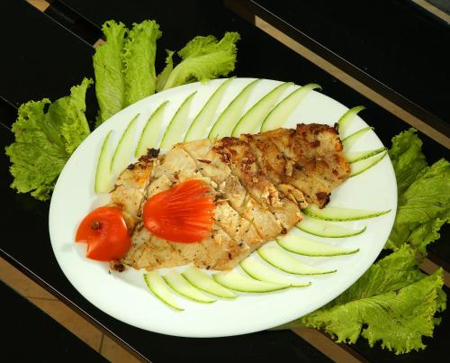 a plate of food with meat and vegetables on it at Hotel C7 Munnar in Munnar