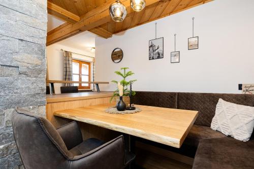 a dining room with a wooden table and chairs at Ferienparadies Taxen in Sankt Veit im Pongau