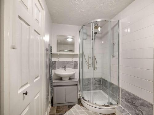 a bathroom with a glass shower and a sink at 2 bed in Denbigh 90461 in Caerwys