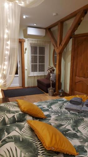 a bedroom with a bed with pillows on it at Apartamenti Dundaga XXL in Dundaga