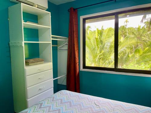a bedroom with a window and a bed and a windowpectpect at Ngermid Oasis Cozy 2 BD 1BA Home, Scenic View, Secluded, Beautiful Location in Koror