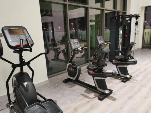 a row of exercise bikes in a gym at Burj Khalifa & City Skyline View, Full Furnish Studio in Dubai