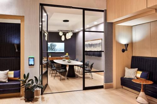 a dining room and living room with a table and chairs at Sheraton Phoenix Downtown in Phoenix