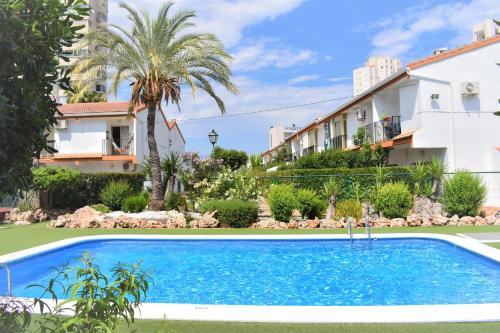 a swimming pool in front of a building at COZY BUNGLOW RINCONDA REAL in Benidorm