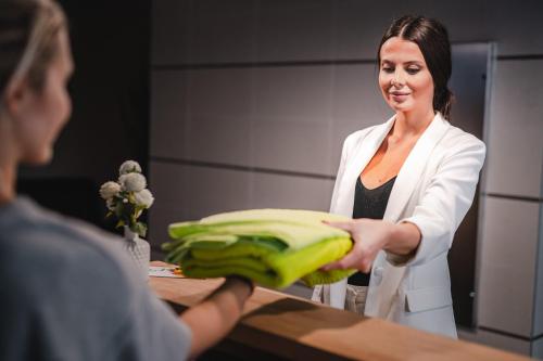 a woman in a white suit holding a bunch of bananas at Holiday Inn Zilina by IHG in Žilina
