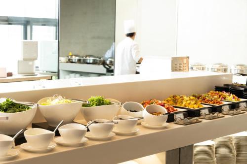 a buffet line with dishes of food on it at Holiday Inn Express Seoul Hongdae by IHG in Seoul