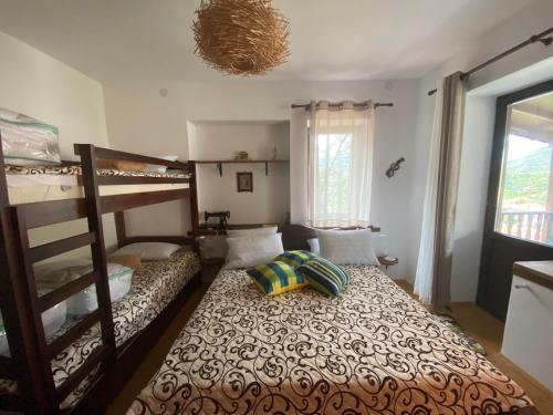 a bedroom with bunk beds and a bed with a pillow at Каменната къща in Borowo