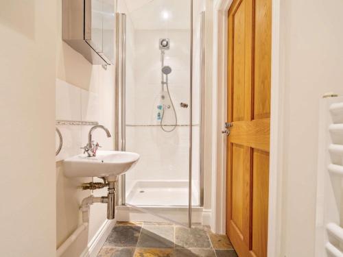 a bathroom with a sink and a shower at 3 Bed in Ellingham 90380 in Eglingham