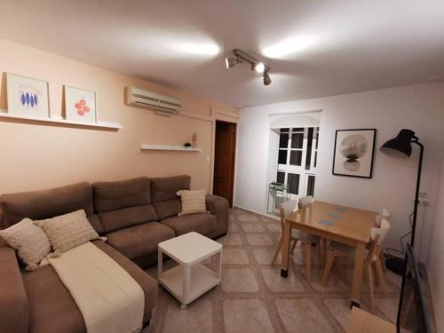a living room with a couch and a table at CDZ - Arteaga- two rooms with queen bed in Cádiz