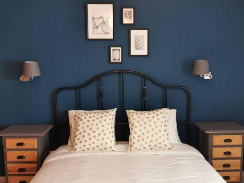 CDZ - Arteaga- two rooms with queen bed في كاديز: غرفة نوم زرقاء مع سرير مع وسائد وطاولتين