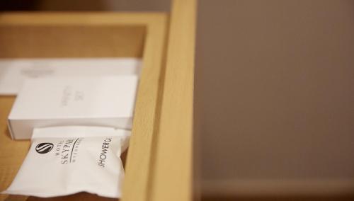a piece of paper sitting on top of a shelf at Hotel Skypark Jeju 1 in Jeju