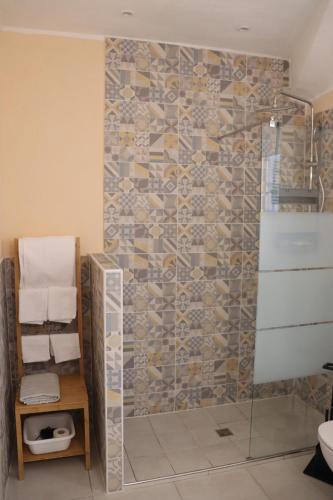 a shower with a glass door in a bathroom at Cascina Angelina in Casteggio
