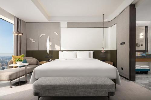 a bedroom with a large white bed and a couch at Crowne Plaza Jinan Runhua by IHG in Jinan