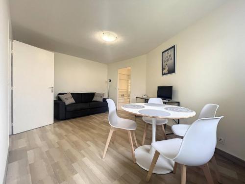 un salon avec une table, des chaises et un canapé dans l'établissement Cannes - Studio 5mn Palais, à Cannes