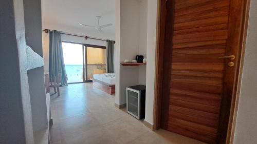 a door to a room with a view of the ocean at Aluna Beach Apartments in Nungwi