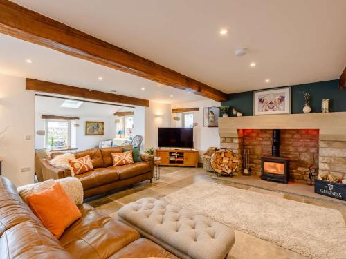 a living room with a couch and a fireplace at 5 Bed in Ingleton 90546 in Burton in Lonsdale