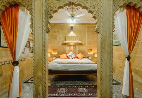 a bedroom with a bed and two curtains at Moustache Jaisalmer in Jaisalmer