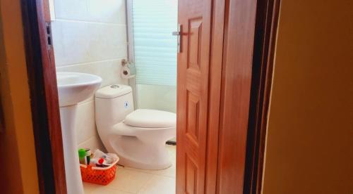 a bathroom with a toilet and a sink at Rossyln Home close to UN, Village Market and Two Rivers Mall in Nairobi