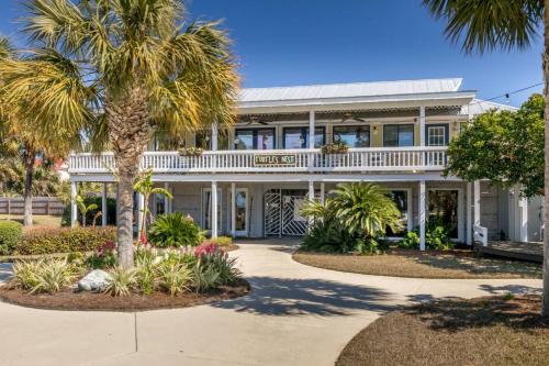 a house with palm trees in front of it at Harbor Island E204 in Oceanmarsh Subdivision