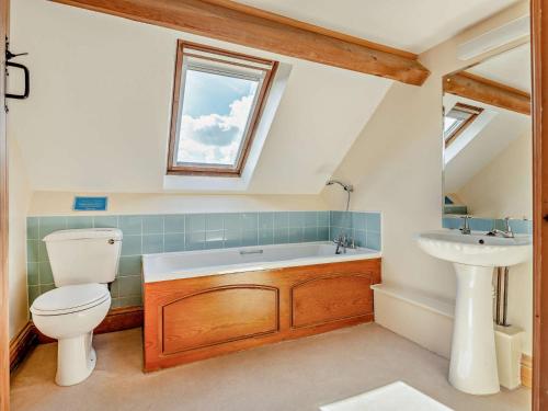 a bathroom with a toilet and a sink at 4 Bed in Hay on Wye 90375 in Builth Wells