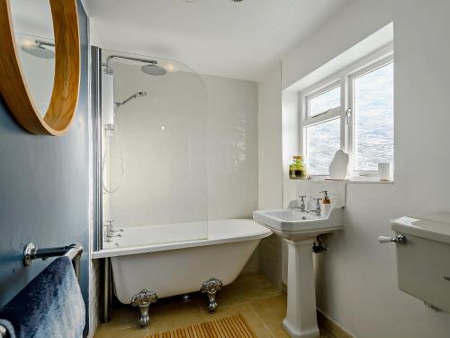 a white bathroom with a tub and a sink at 2 Bed in Great Walsingham 90535 in Little Walsingham