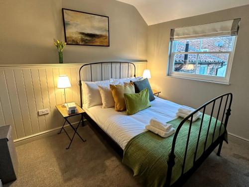 a bedroom with a bed with pillows and a window at 1 Bed in Fakenham 90683 in Fakenham