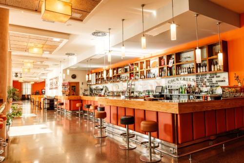 a bar in a restaurant with bar stools at Hotel Monarque Costa Narejos in Los Alcázares