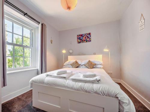 a bedroom with a white bed with a window at 1 Bed in Keswick 90646 in Keswick