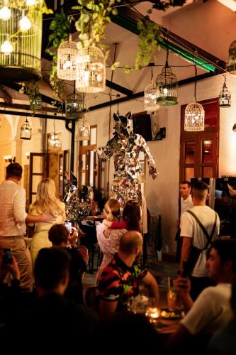 a crowd of people standing in a room with a mannequin at Bazaar Boutique Residence in Budapest