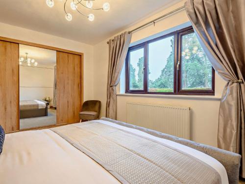 a bedroom with a bed and a large window at 3 Bed in Kington 90768 in Kinnerton